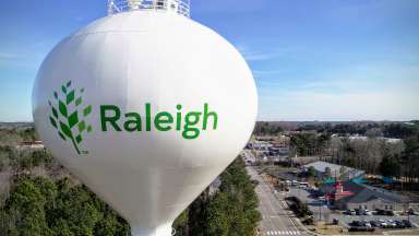 Close up aerial view of the water tower with Raleigh written across it