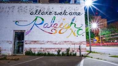 Mural that says &quot;All are Welcome Raleigh NC&quot;