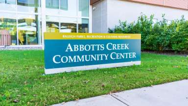 the front of Abbotts Creek community center with sign