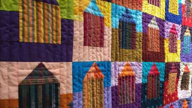 a close up of a colorful African American quilt