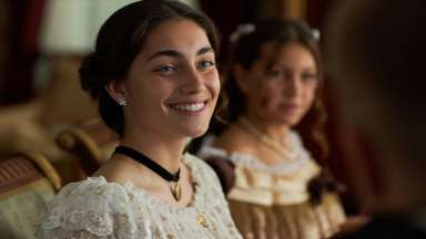 a person in an old time clothes smiling