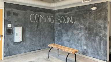 Corner chalk wall with the words coming soon written in chalk