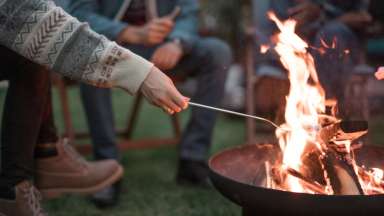 Roasting marshmallows over open fire