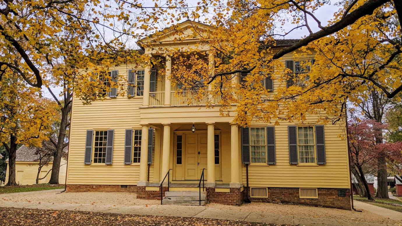 outside of the mordeai historic house with fall foliage 