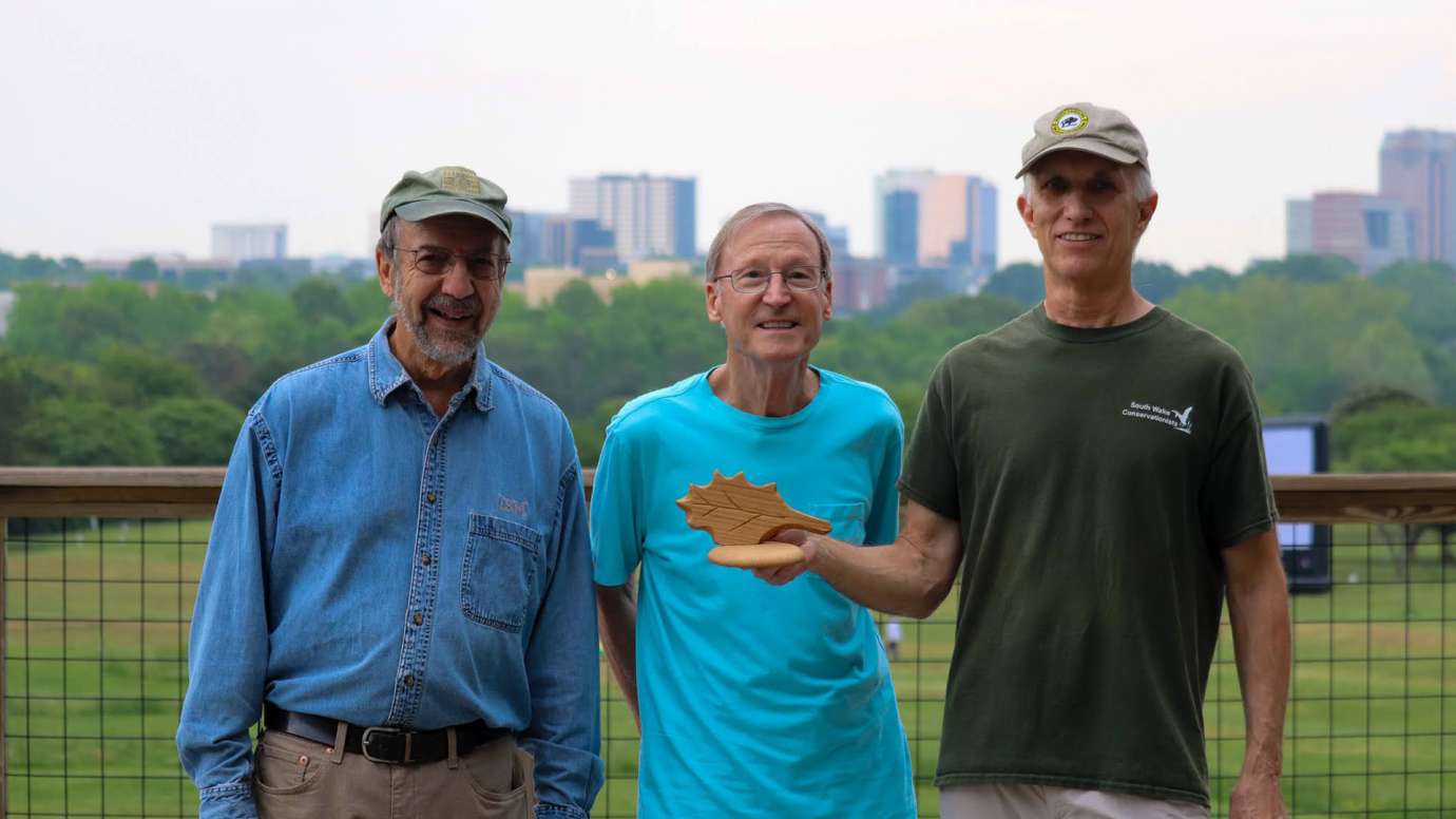 Three members of South Wake Conservationists pose with award