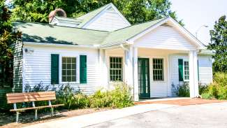 Quaint one-story cottage with shutters at Anderson Point Park