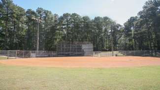 North Hills Park youth baseball field including diamond, benches and fencing.