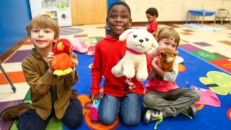 A group of young kids participating in a preschool program