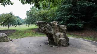 A large boulder used for climbing, with different sides for different difficulty levels 