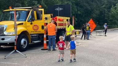 a construction truck with children visiting