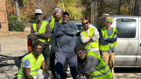 The Great Raleigh Cleanup Executive Director and six workers pose in front of a truck.