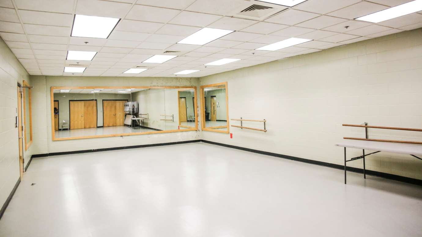 A dance studio with bars and mirrors