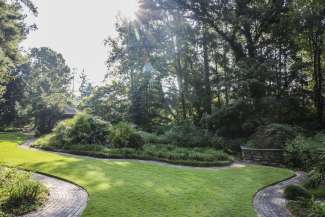 A wide shot of the daylily garden with shrubs, trees, flowers and a gazebo