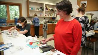 Two women creating jewelry