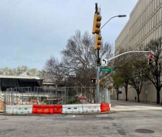 image shows the closed portion of sidewalk at McDowell Street and Hargett Street. 